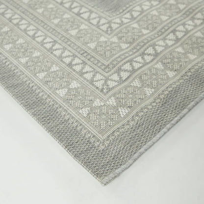 Tapis d'intérieur/extérieur à bordure transitionnelle Carew