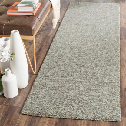Tapis moderne en laine fait main SAFAVIEH avec bordure en palmier de l'Himalaya